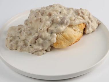 Biscuits and gravy with two eggs.